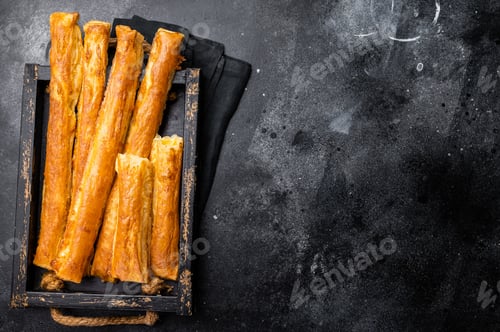 Preview: Bread sticks with cheese and salt. black background. top view