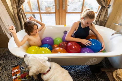 Preview: Young boy and his older sister in bathtub filled with water balloons