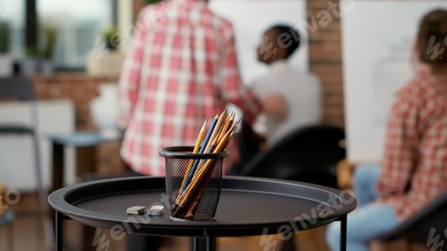 Preview: Colorful pencils and artistic instruments on table in art class