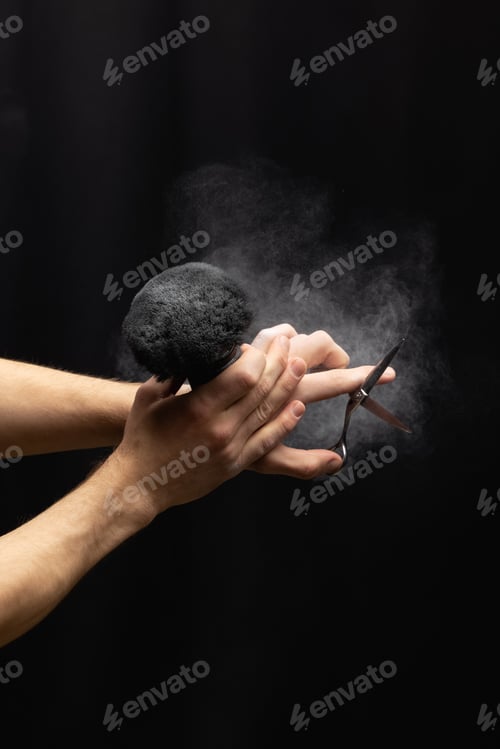 Preview: barber is holding a brush for powder hairdresser and scissor