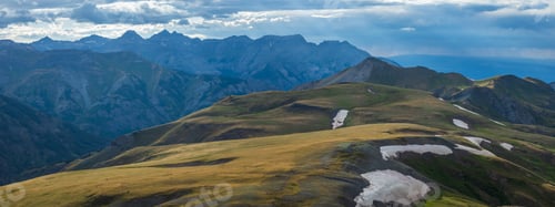 Preview: Mountain tundra field with snow and distant clouds