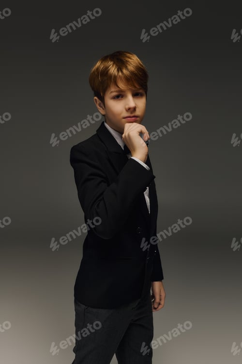 Preview: Sophisticated preteen boy showcasing elegant fashion in studio setting