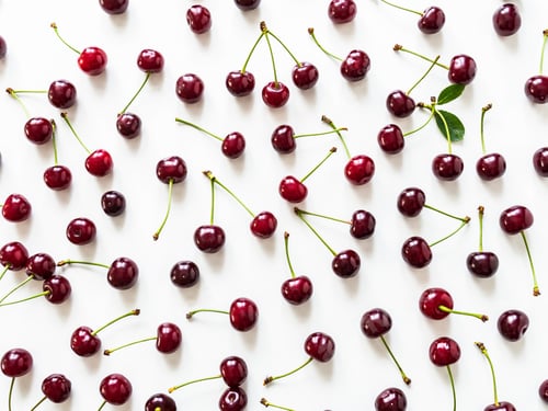 Preview: Large ripe cherry berries with leaves and drops of water background. Natural summer food background.