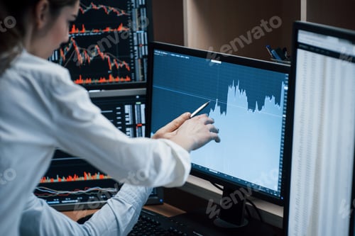 Preview: Team of stockbrokers are having a conversation in a office with multiple display screens