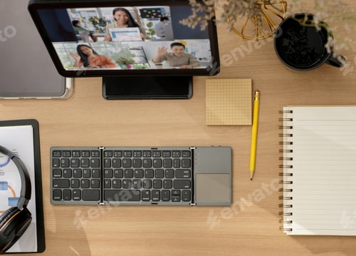 Preview: top view desk when video conference online with team at home