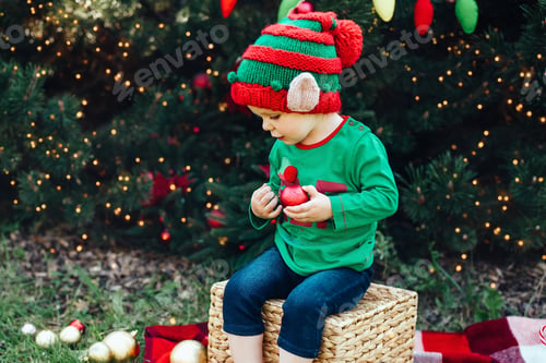 Preview: Christmas in july. Child waiting for Christmas in wood in july
