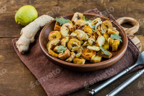 Preview: Golden fried plantains served with sautéed onions, a traditional