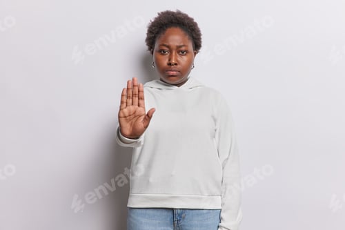 Preview: Photo of serious displeased overweight Afro American woman shows stop gesture keeps palm raised