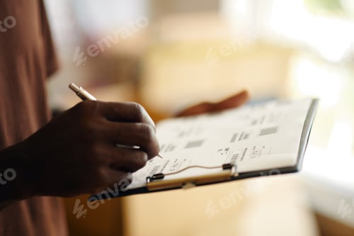 Preview: Man Filling Delivery Form In Warehouse