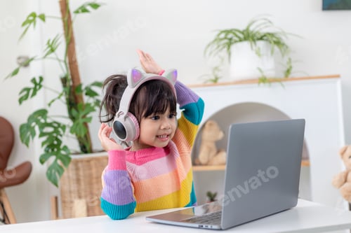 Preview: Smiling little Asian girl have a video call distant class with teacher using laptop,
