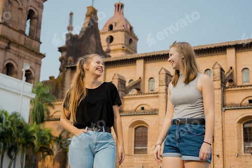 Preview: Young female friends standing on the background of Santa Cruz de la Sierra cathedral
