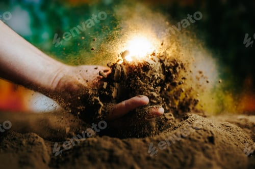 Visualização: Uma mão agarra o solo, liberando uma nuvem de poeira iluminada por uma luz forte