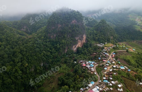 Preview: Top view of countryside road passing through the green forrest and mountain