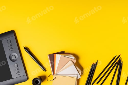 Preview: top view of drawing tablet, colorful palette and pencils near stylus on yellow