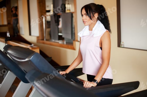 Preview: Fit women running on treadmills doing cardio training in a gym,Healthy lifestyle concept