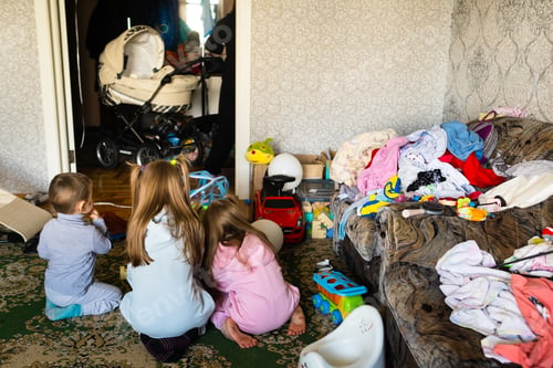 Preview: Three unrecognizable children are playing in a dirty cluttered room