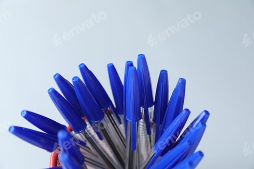 Preview: Many ballpoint pens in holder on light grey background, closeup