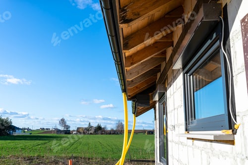 Preview: 100mm diameter yellow PVC pipe connected to the end the gutter on the roof protected against water