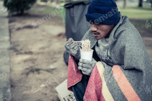 Preview: The beggars sat wrapped in cloths and eating noodles.