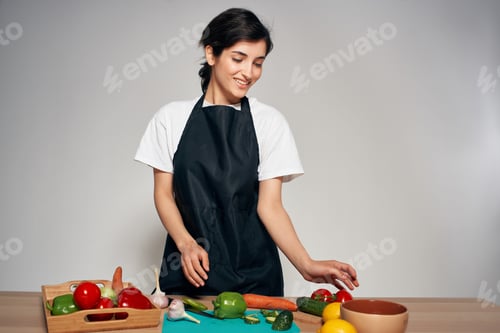 Preview: cheerful housewife in black aprons vegetables food cooking