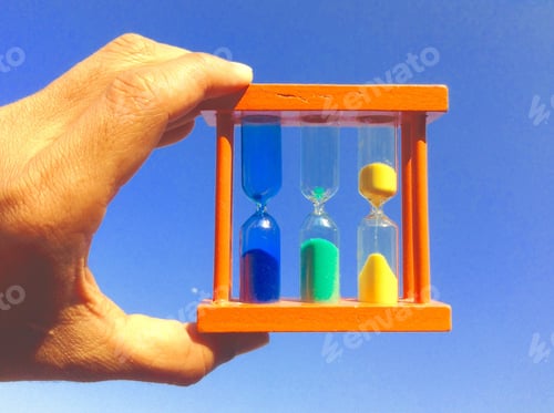Preview: Hourglass in hand with blue sky background.