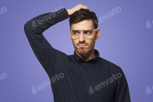 Preview: Pensive businessman thinking, scratching his head trying to find solution