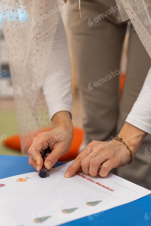 Preview: The teacher explains the task in the English lesson for children.