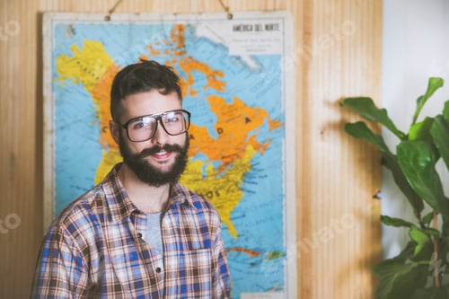 Preview: Portrait of bearded man wearing glasses in front of a map