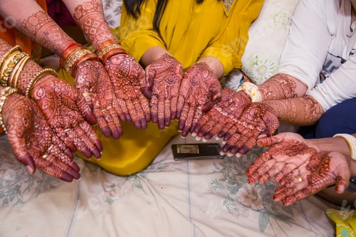 Preview: Of ladies showing off their Mehndi design on their hands.