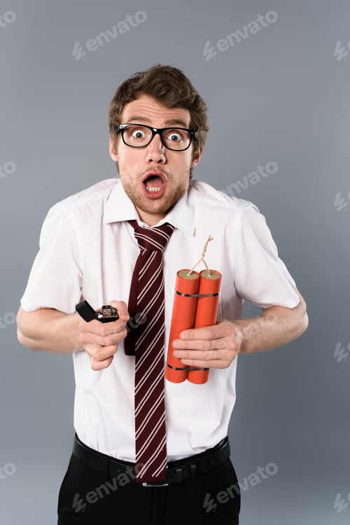 Preview: shocked businessman in glasses holding lighter and dynamite on grey background