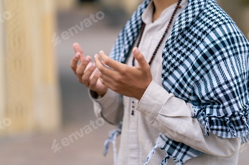 Preview: Close-up shot of the rosary and hands of an Arab man praying in the courtyard of a Muslim mosque
