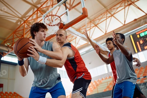 Preview: Below view of basketball players in action during a match.