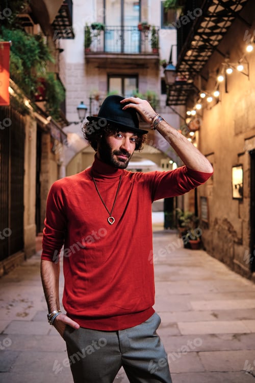 Preview: Man with hat posing while looking at the camera outdoors