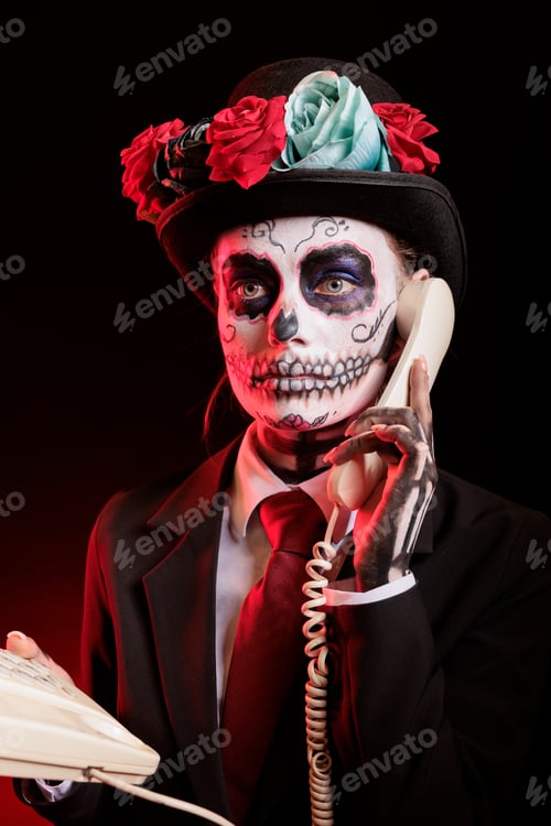Preview: Woman talks on cord telephone during Dia de los Muertes indigenous rites