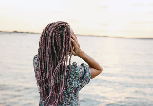 Preview: Happy romantic young woman with braids in sunglasses enjoy her life on the beach