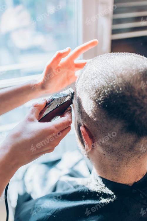 Preview: Woman barber cutting hair using razor
