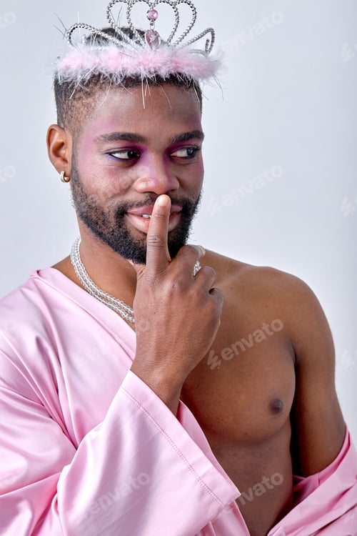 Preview: Adorable black half-naked man in crown posing at camera like a fairy, princess