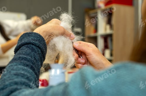Preview: Hands crafting wool in workshop setting