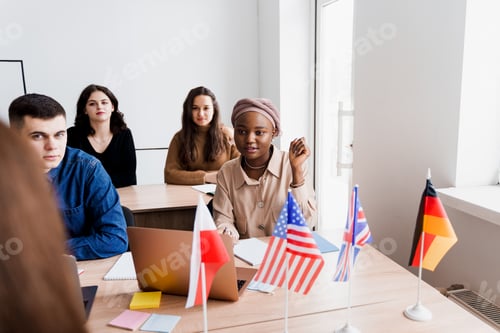 Preview: Private school study, teacher explains grammar using laptop, flags UK, Germany, Poland