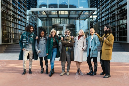 Preview: Group of modern businessmen and women outside building posing happily and having good time