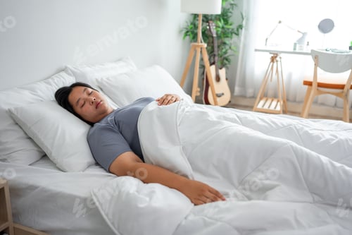 Preview: Asian plus-size woman in pajamas sleeping in the morning with happiness.