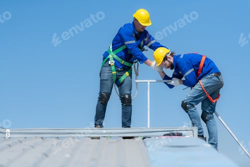 Preview: A young technician intern working on solar panels is fear of heights with senior engineers