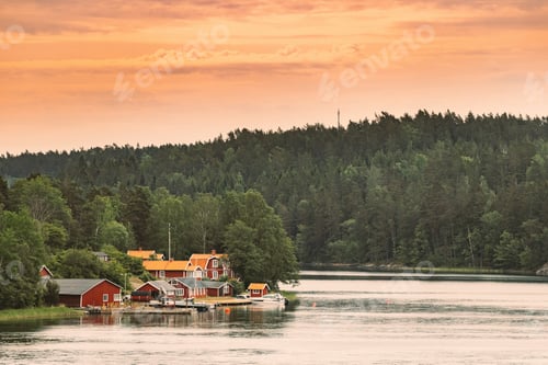 Preview: Sweden. Many Beautiful Red Swedish Wooden Log Cabins Houses On Rocky Island Coast. Lake Or River