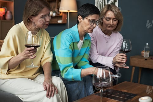 Preview: Middle Aged Caucasian Women Socializing and Playing Cards Together Indoors