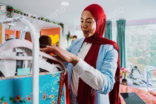 Preview: Muslim woman browsing clothes, shopping in fashion boutique