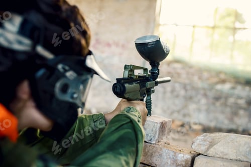 Preview: Person in a mask playing paintball in an abandoned building under the lights