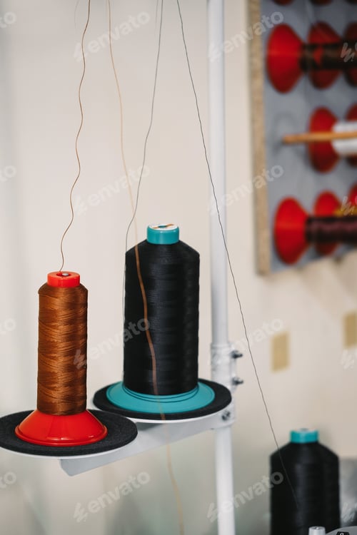 Preview: Spool of threads. Colourful thread spools hanging on the wall