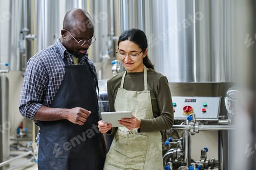 Preview: Couple of engineers using tablet pc at their work