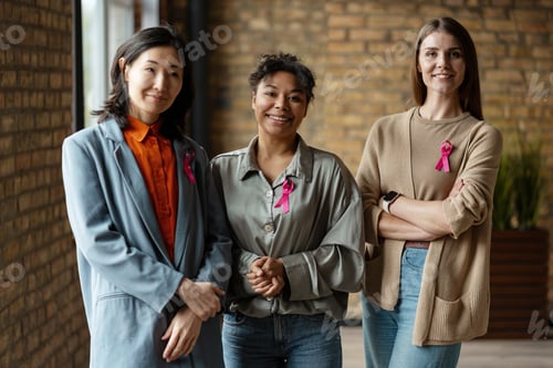 Preview: Businesswomen wearing pink ribbons supporting breast cancer awareness