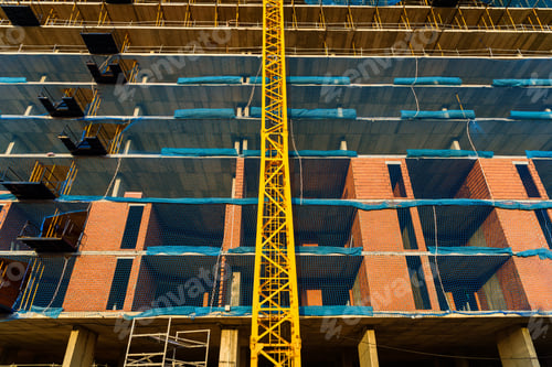 Preview: Yellow crane in a construction site to lift large weights of construction material